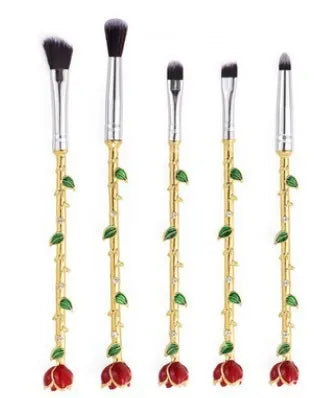 Beauty and the Beast makeup brushes with character-themed bristles and golden or silvery handles