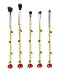 Beauty and the Beast makeup brushes with character-themed bristles and golden or silvery handles