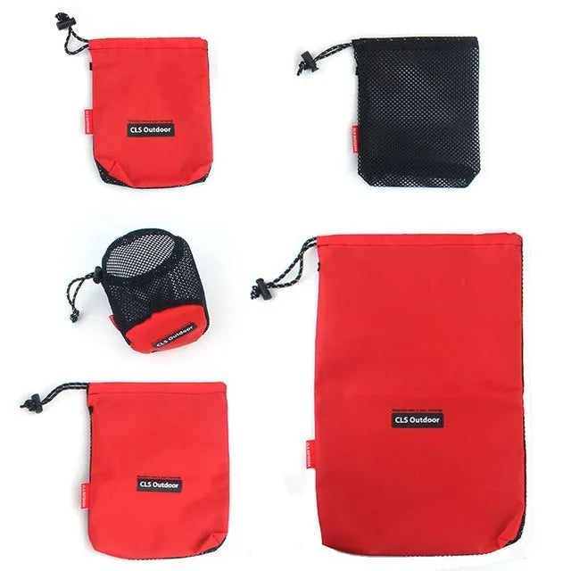 Red five-piece outdoor travel storage bag set with zipper closures on open bags showing internal pockets