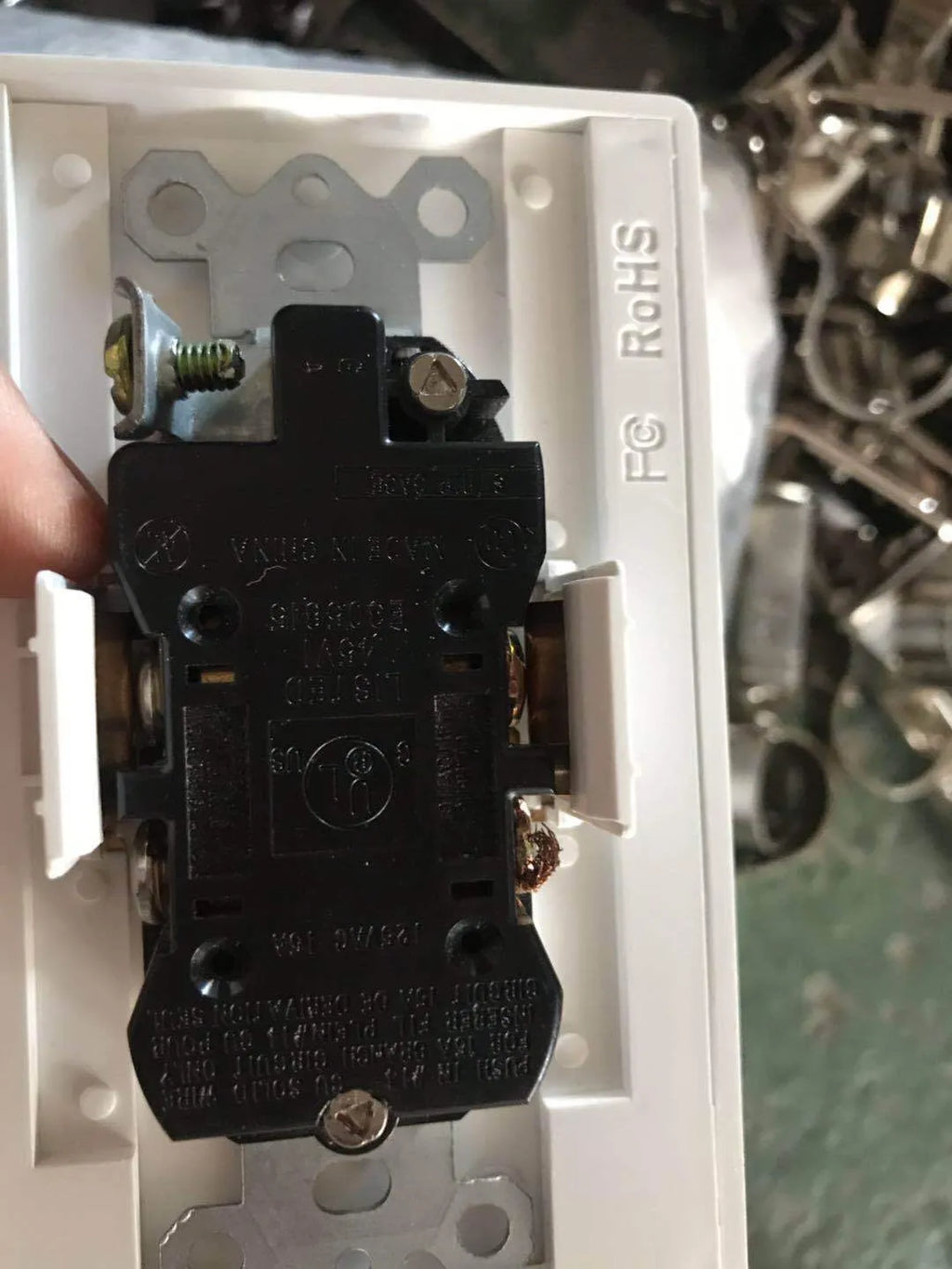 White plastic socket induction LED night light plugged into a wall outlet