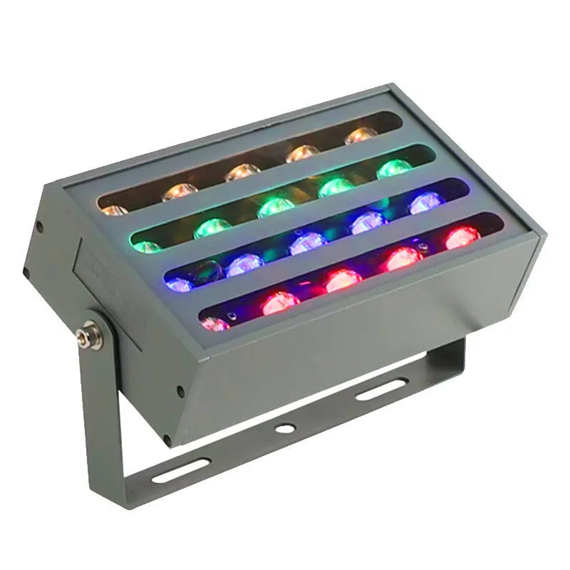 Silver aluminium alloy outdoor LED spotlight projecting multicoloured light onto a tree.
