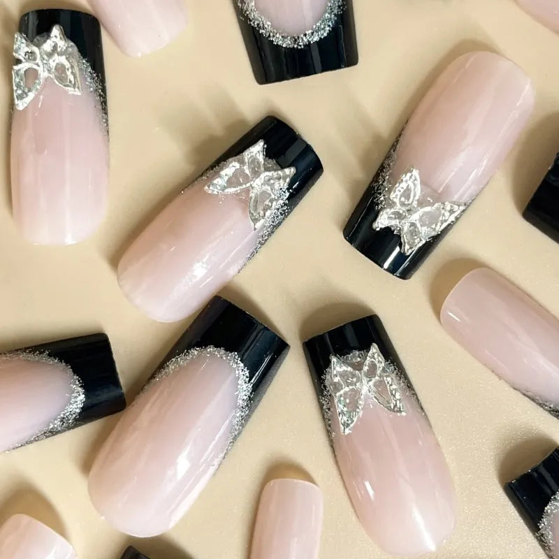 Black French style false nails with glittering butterfly patterns in medium length wearable armour design