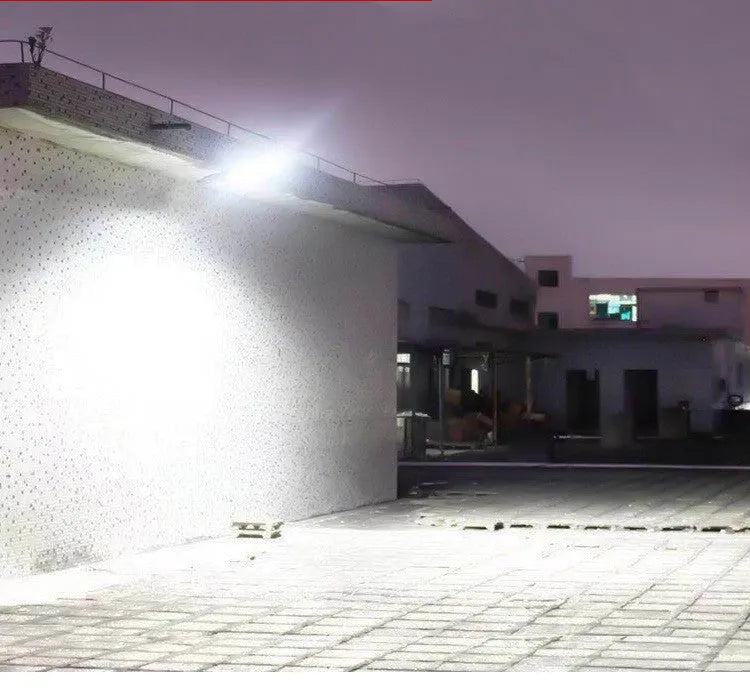 Black outdoor solar motion sensor security light mounted on a wall or fence post.