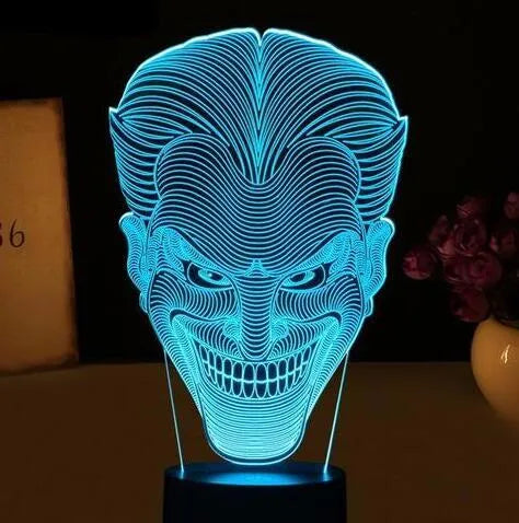 USB-powered 3D acrylic LED table lamp with remote control on a desk, displaying a gradient colour mode.