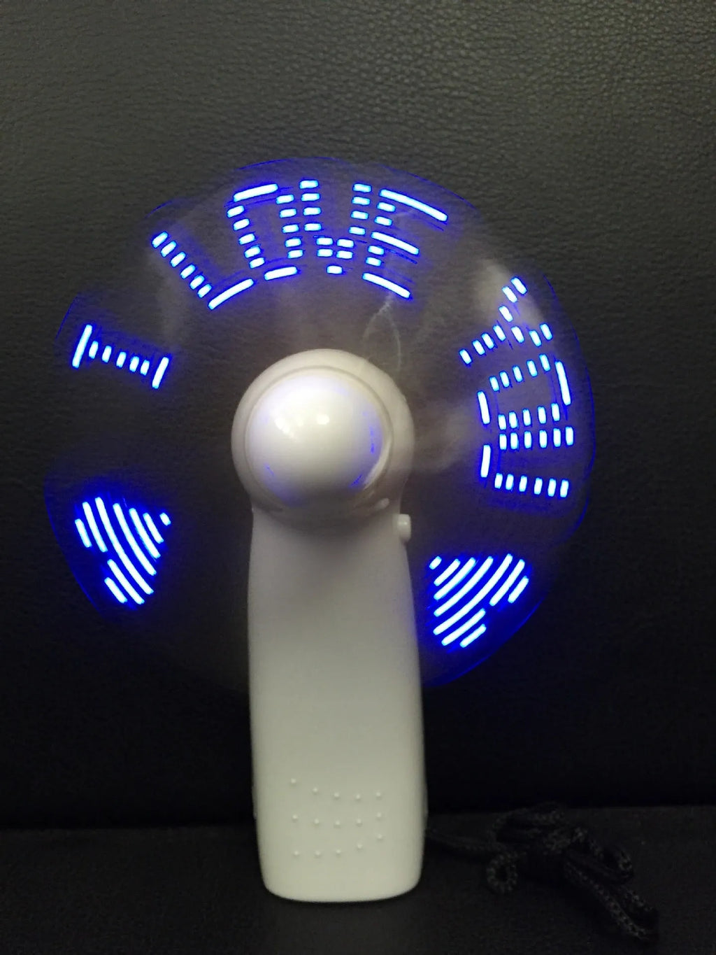 White handheld mini fan with flashing blue and red LED 'I Love You' pattern display