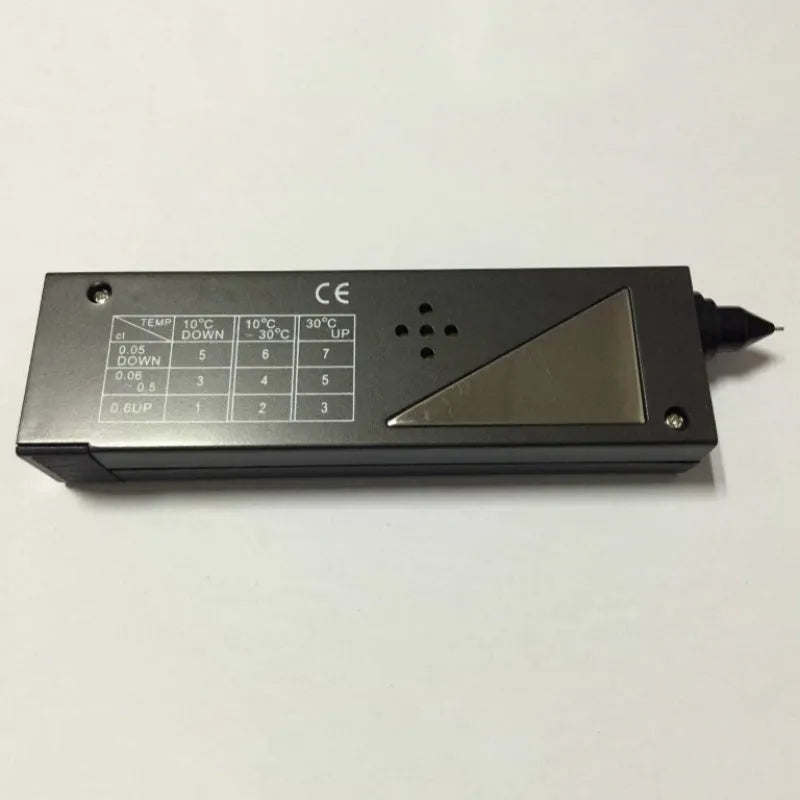 Black handheld second generation diamond thermal conductivity meter on a grey background.