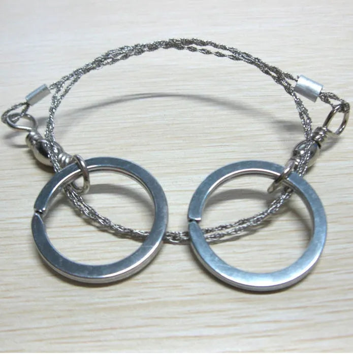 Survival wire saw with thumb rings extended to 70cm total length on a background.