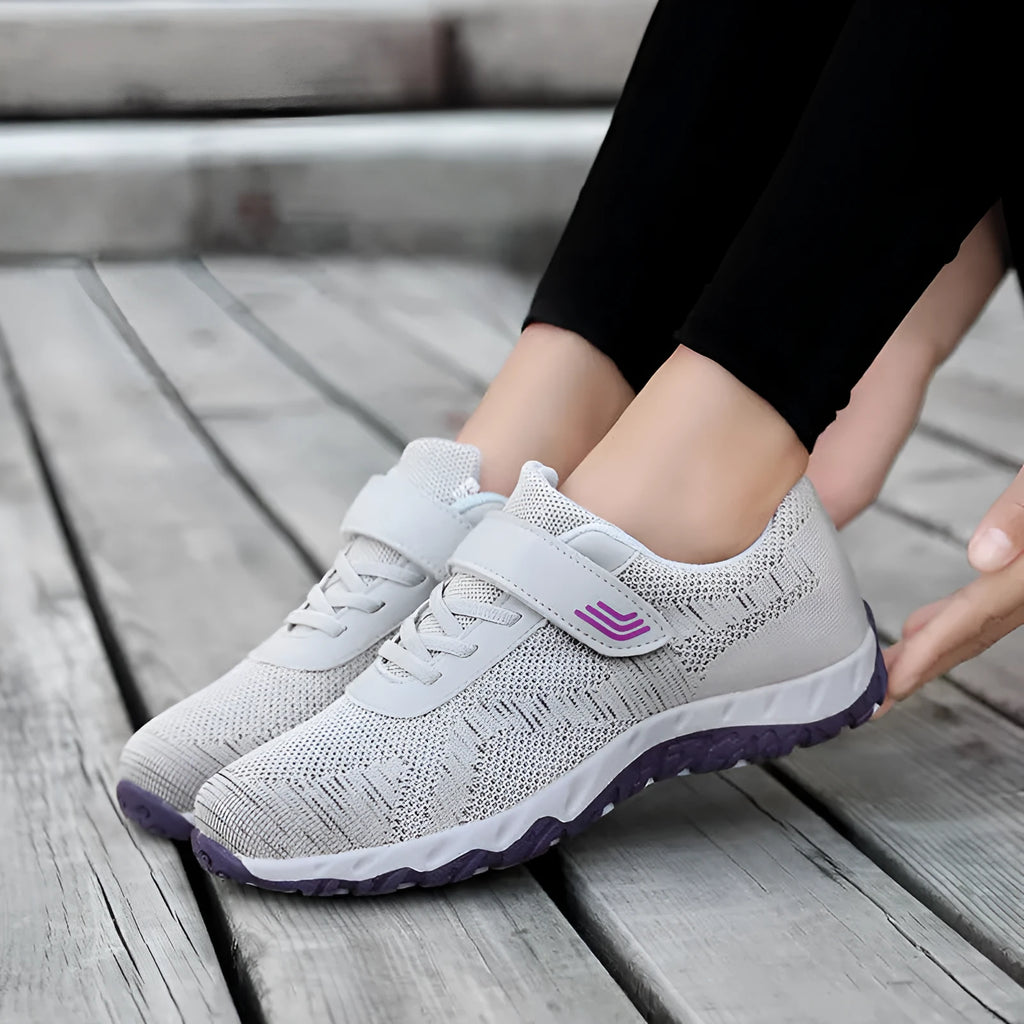 Grey purple women's low-top shoes with a velcro strap and wedge sole on a white background.