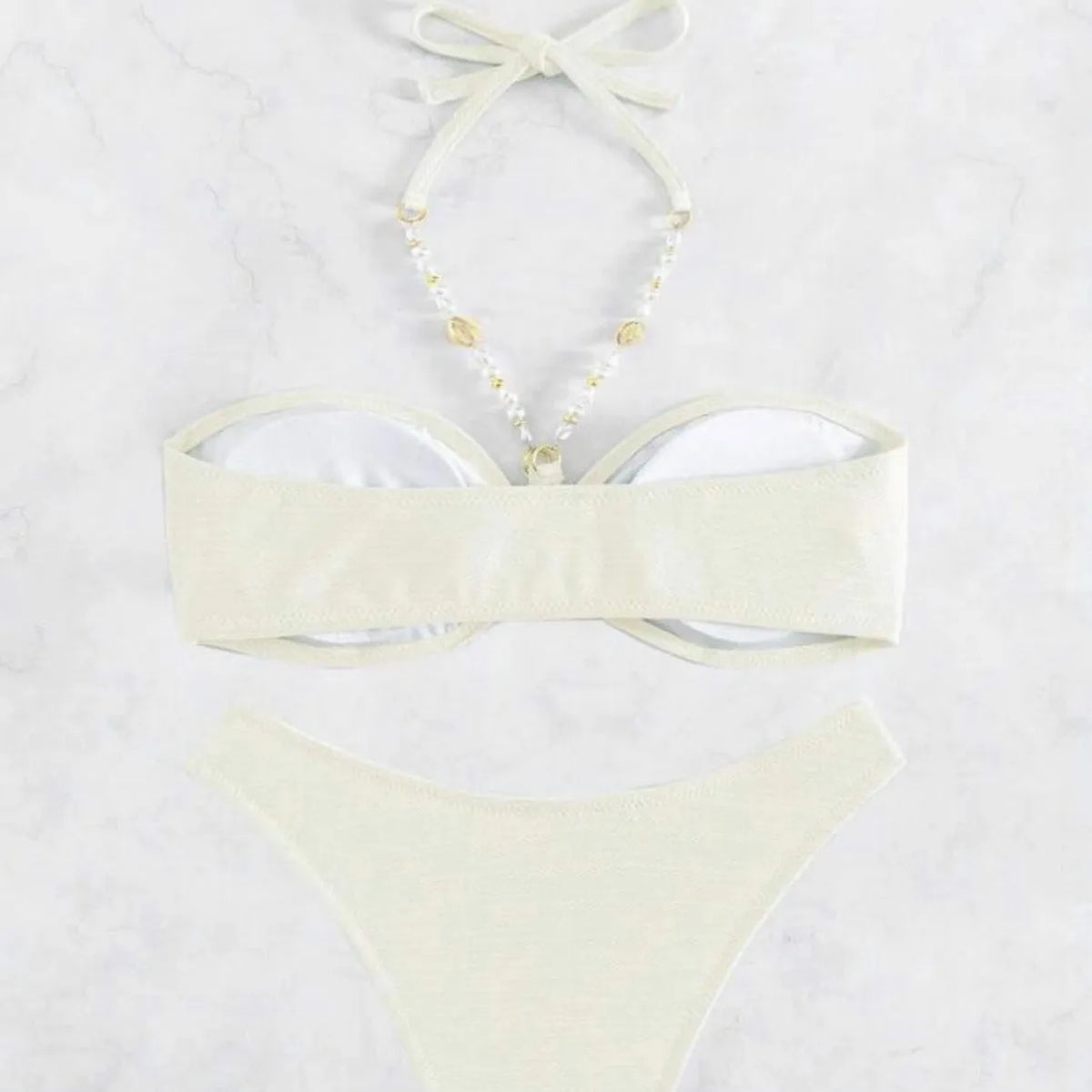 Women's solid colour halterneck bikini set on a mannequin, showing front view in one of four colour options.