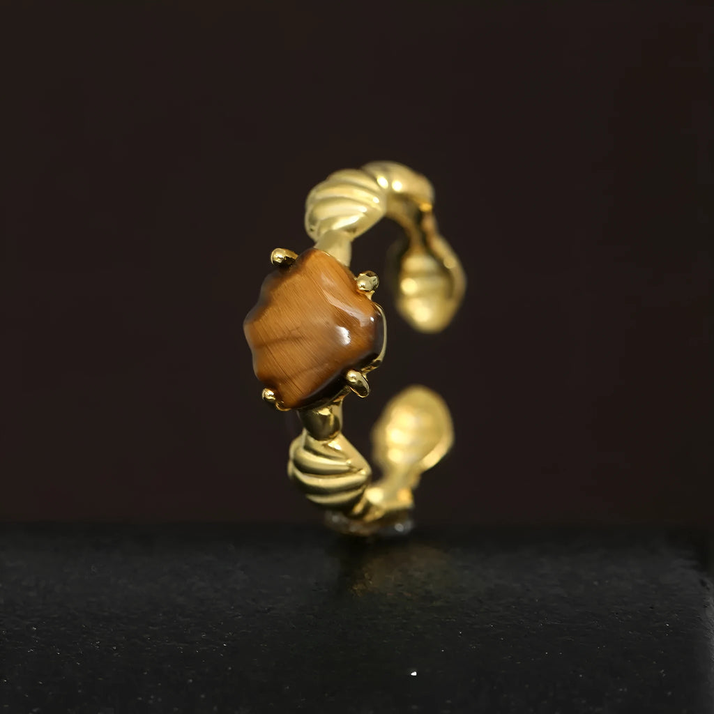 Adjustable silver ring with a white shell and tiger eye design in a choice of gold or white gold finish.