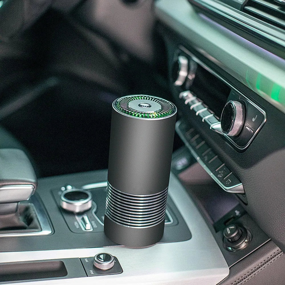 Black car wireless air purifier with negative ion generator on a car dashboard.