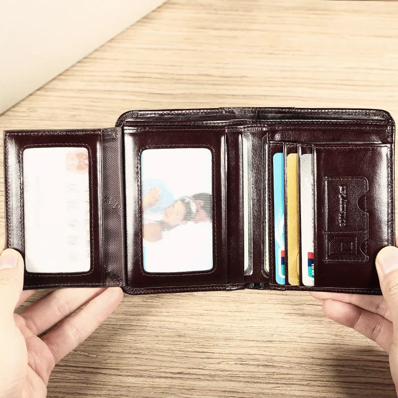 Men's brown leather wallet open to show card slots, ID window, coin pocket, and banknote fold.