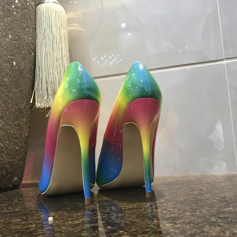 Rainbow patent leather pointed toe stiletto heels with thin ultra-high heel on white background