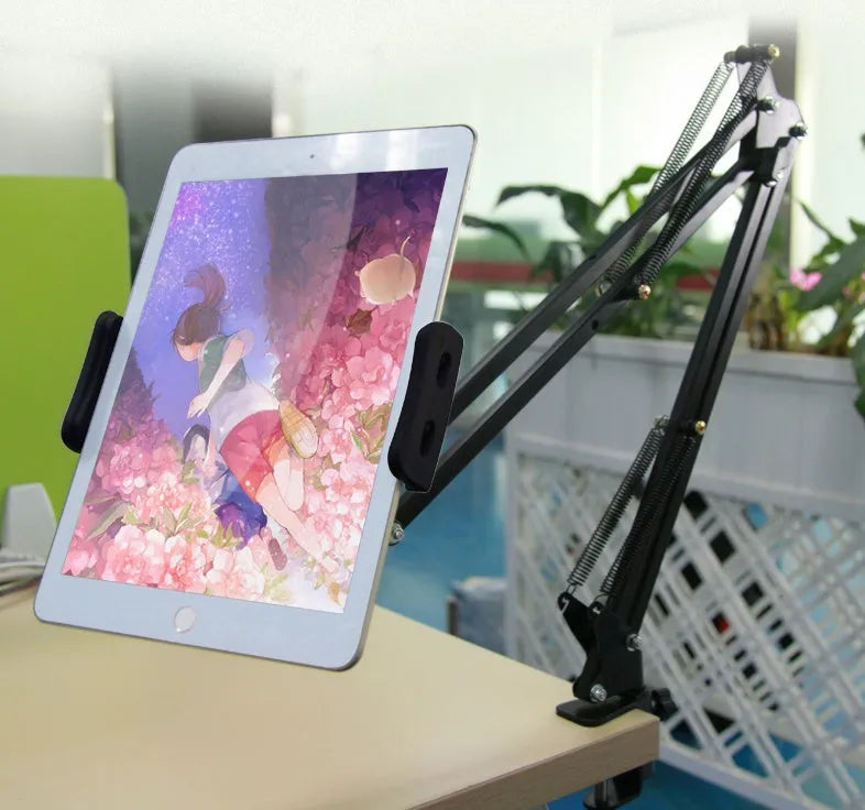 Adjustable black and white phone tablet stand on flat surface with mobile device