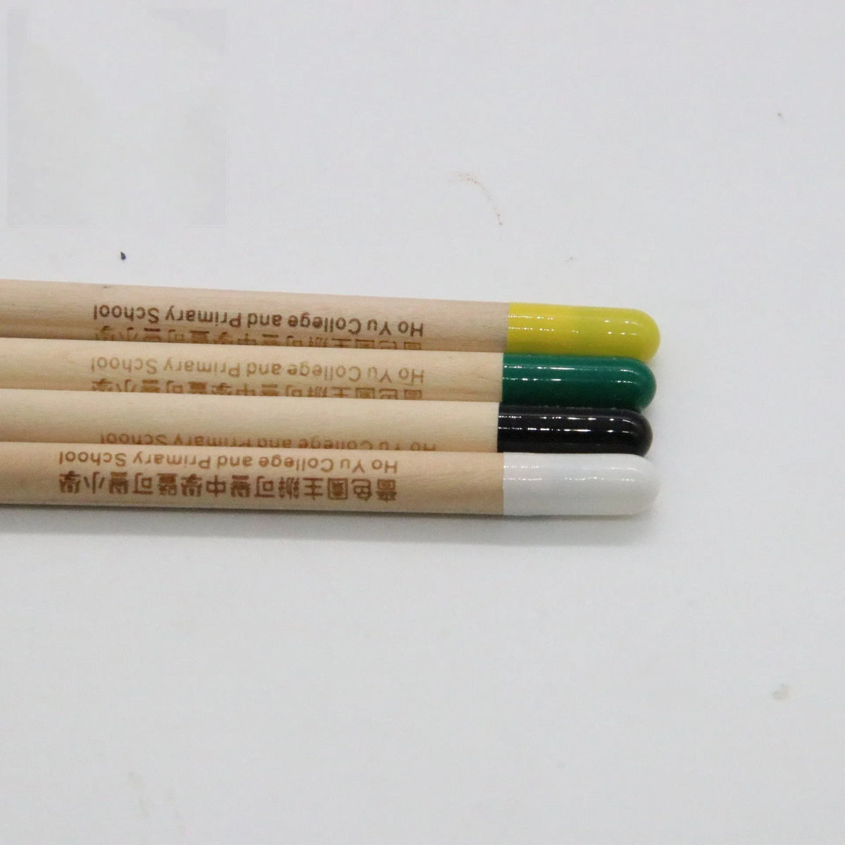 HB Seed Pencil with coloured degradable capsule containing plantable seeds on a soil background.