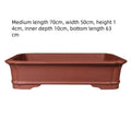 Large rectangular handmade purple clay flowerpot showing its thickened walls and natural finish.