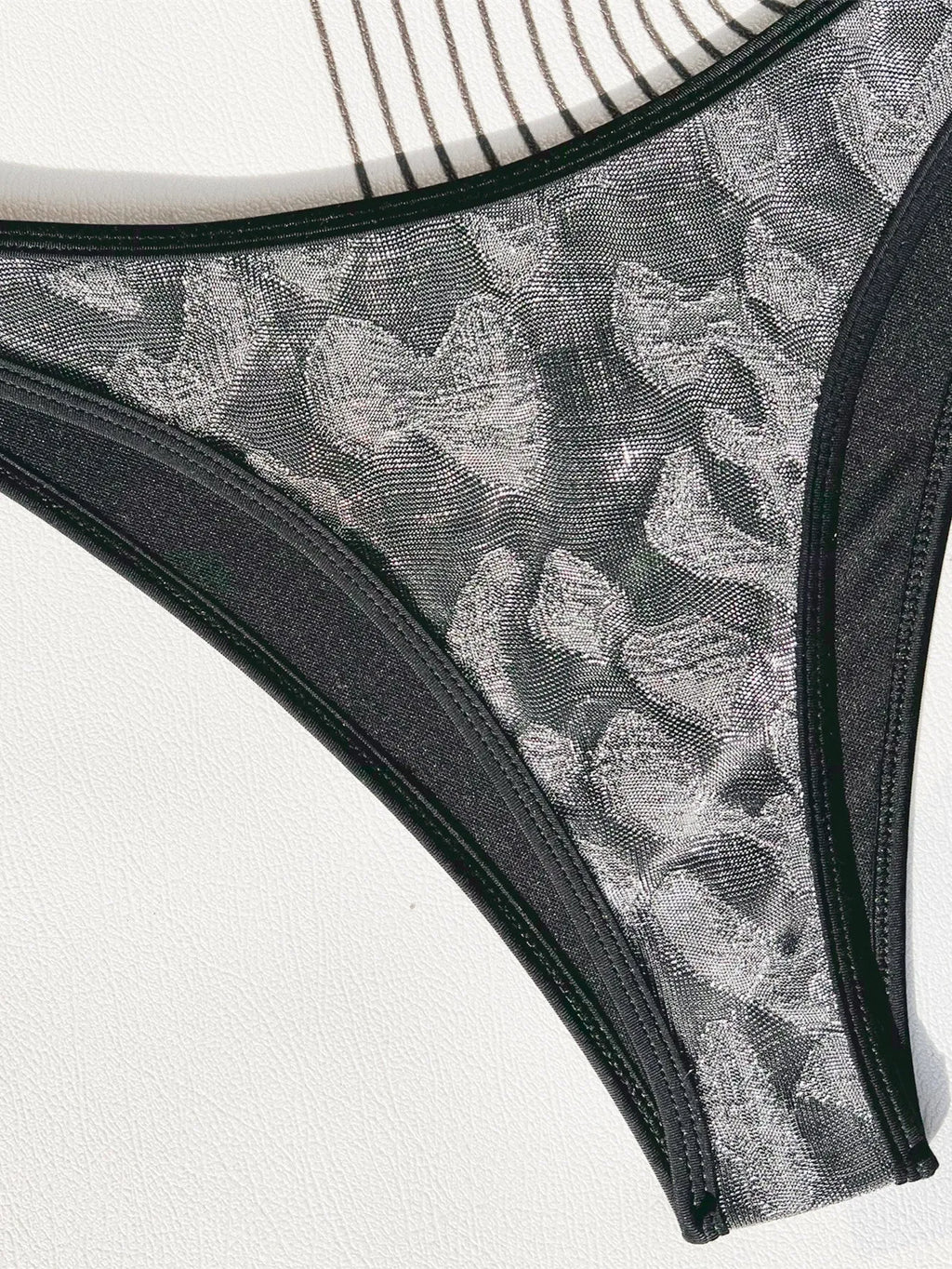 Ladies black polyester bikini set with adjustable straps, shown on a mannequin.