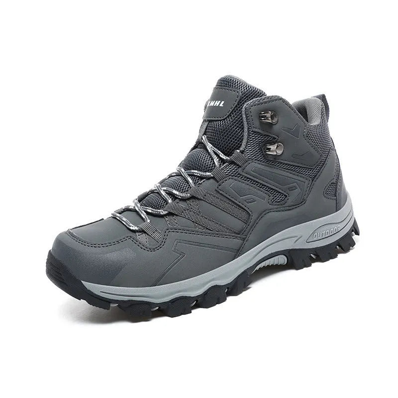Hiking sneaker with flannel upper and rubber sole in black, shown on a rocky outdoor path.