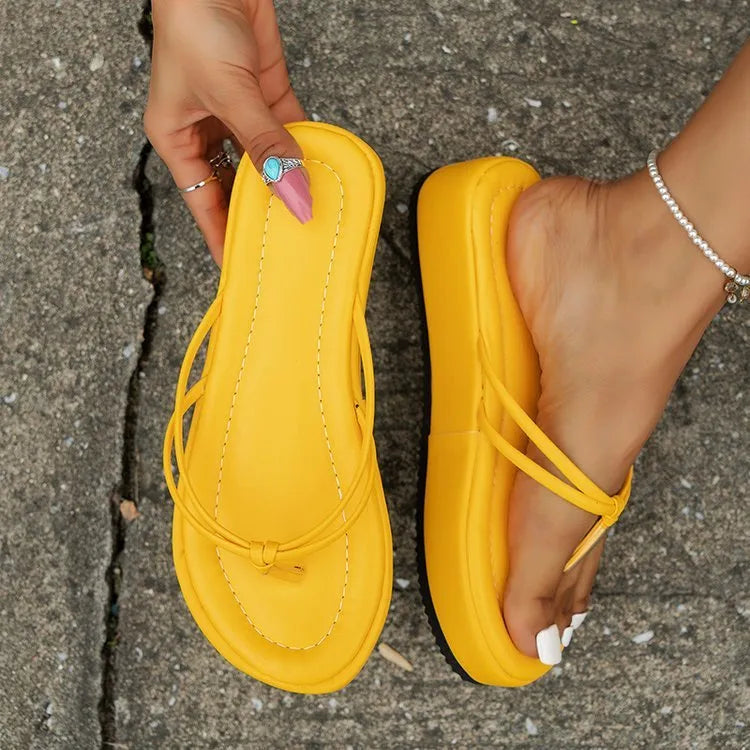 White thick-soled flip-flops with herringbone pattern PU upper and rubber sole.
