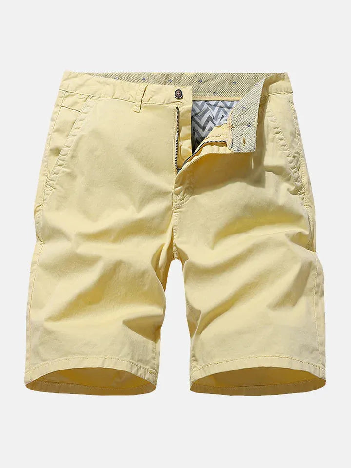 Man wearing blue denim casual shorts with an elastic waistband, showcasing the loose fit and straight leg design.