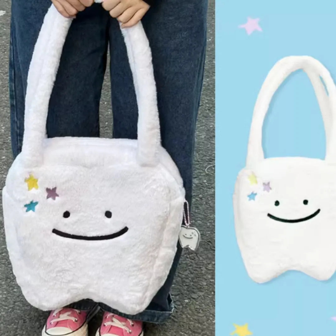 White plush shoulder tote bag with large tooth design and cute teeth pattern, showing zipper closure