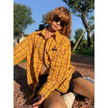 Dopamine yellow plaid loose fit shirt on hanger showing cardigan style and chemical fibre blend fabric