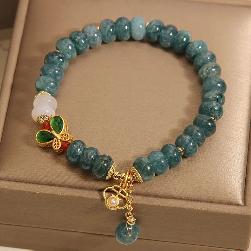 Blue water jade abacus bead crystal bracelet with butterfly charm and white agate beads