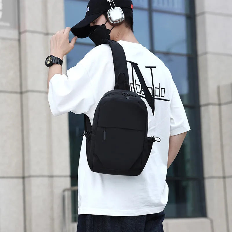 Men's grey waterproof large chest bag with shoulder strap, showing front pocket and main compartment.