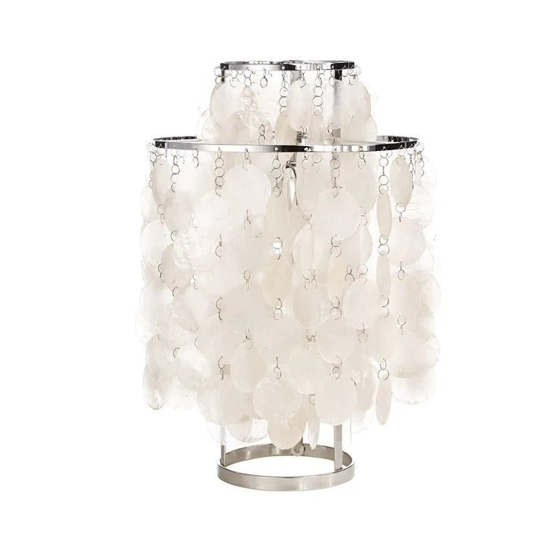 Modern single-head Shell bedside table lamp in chrome finish on a wooden table.