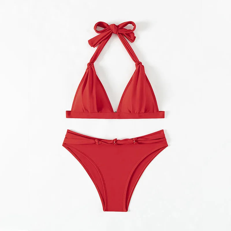 Red women's halterneck bikini with lace-up front closure and split-leg shorts