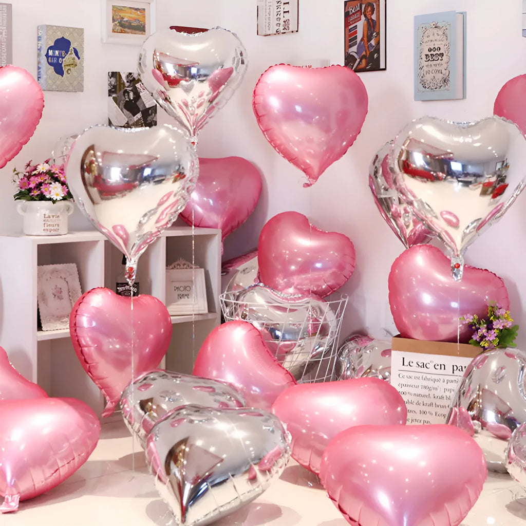 Five peach heart shaped aluminum balloons in red, blue, rose, and silver floating in mixed 10 and 5 inch sizes