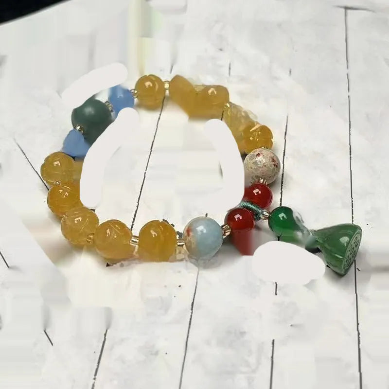 Carved bodhi root bracelet with pumpkin lotus beads and white jade lotus detailing in multiple bead sizes