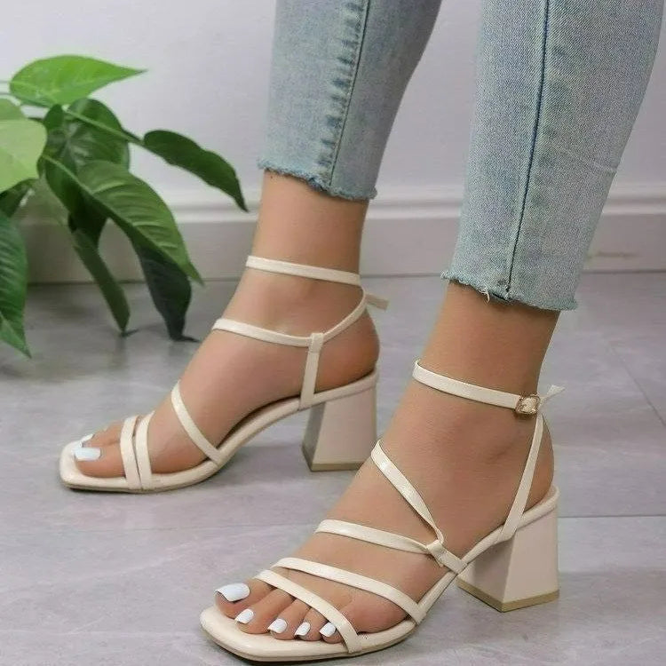 Plus size beige open toe slippers with a square toe and an adjustable ankle buckle strap on a rubber sole.