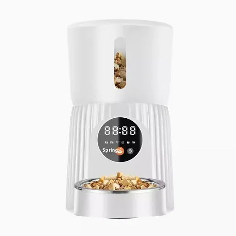 Black automatic pet feeder with digital display and food container showing portion control mechanism