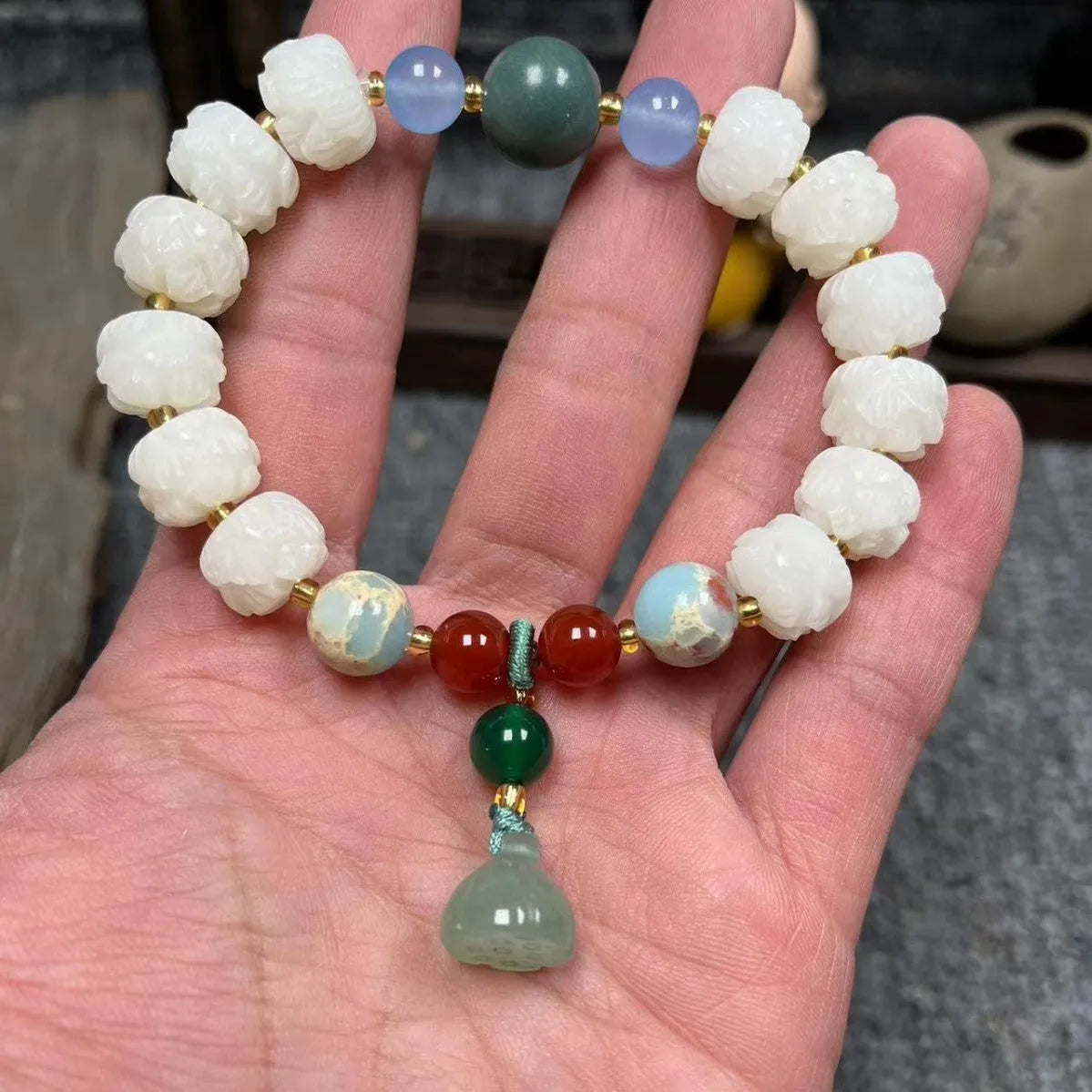 Carved bodhi root bracelet with pumpkin lotus beads and white jade lotus detailing in multiple bead sizes