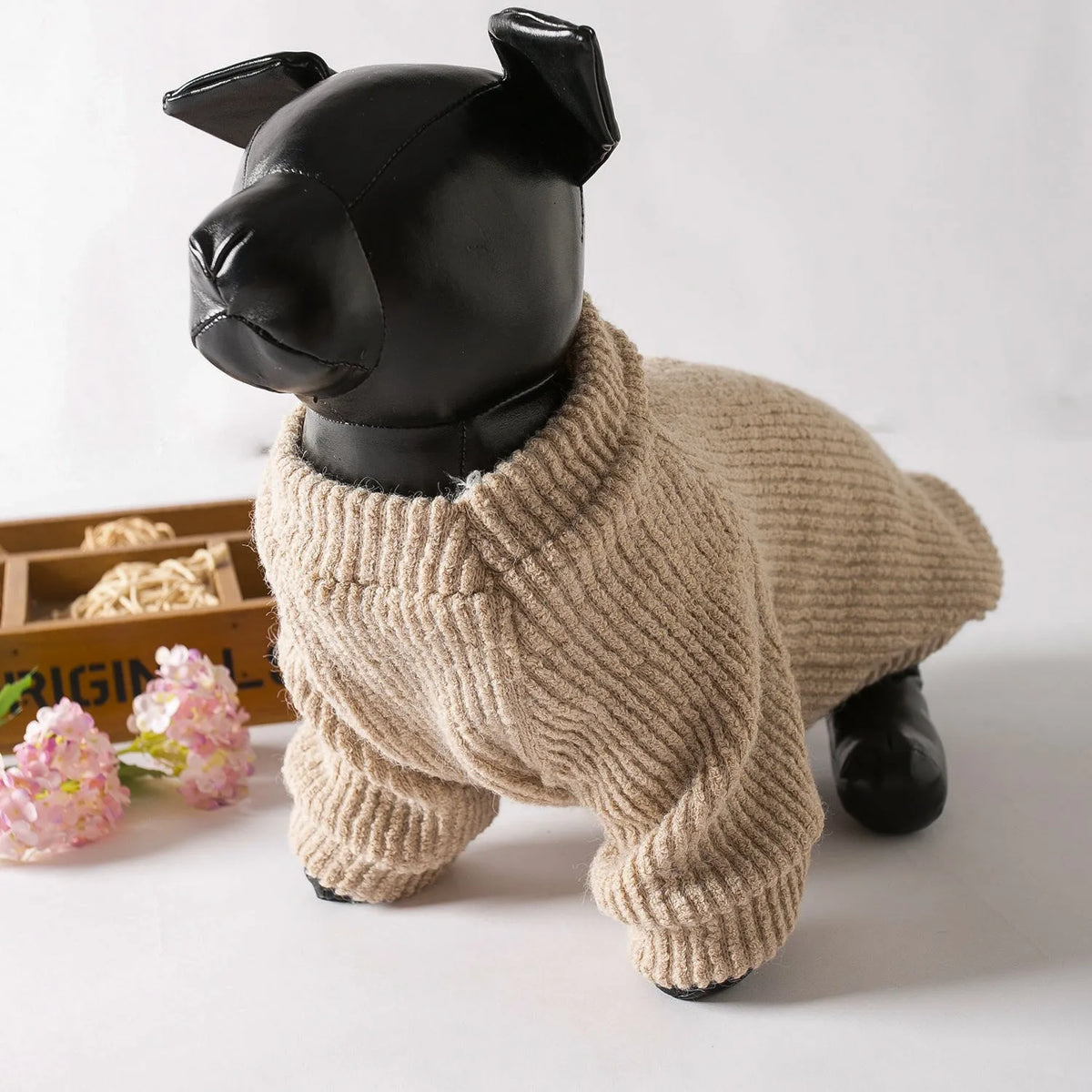 Brown cloth pullover sweater on a small dog like a Bichon or Pomeranian