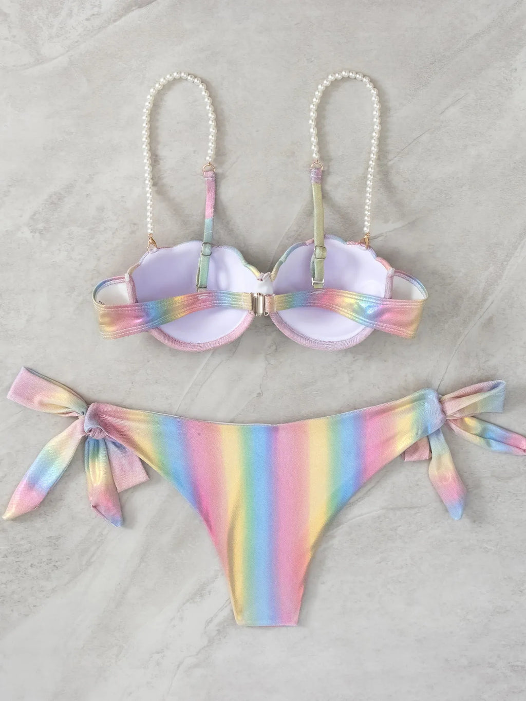 Women's shell rainbow colour split tied bikini swimsuit with triangle top on a neutral background.