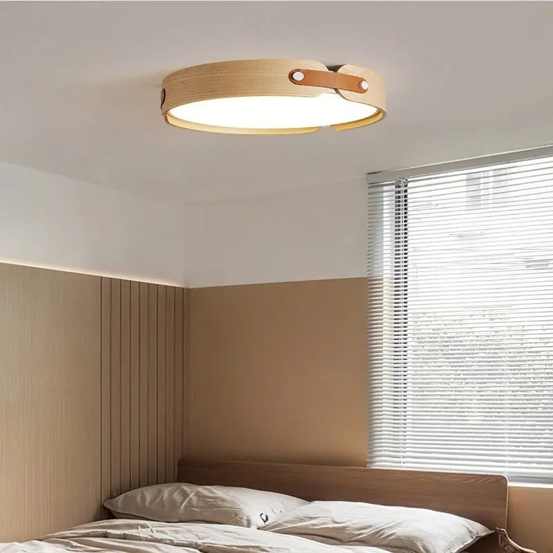 Japanese style wooden ceiling lamp with a PMMA shade in a warm light colour, shown in a bedroom setting.