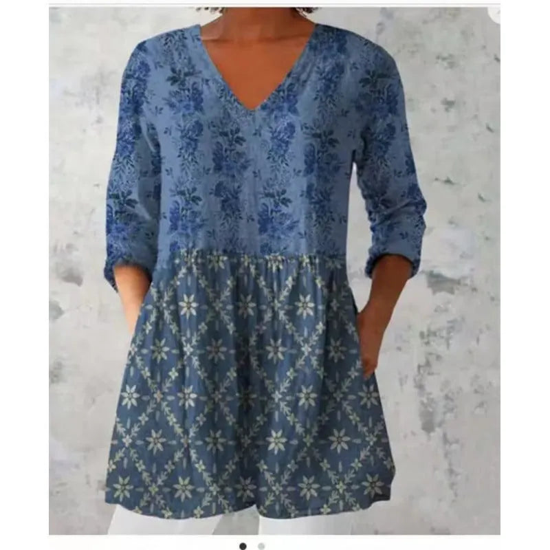 Women's loose-fitting floral print dress with 3/4 sleeves and a wide waist, shown on a hanger.