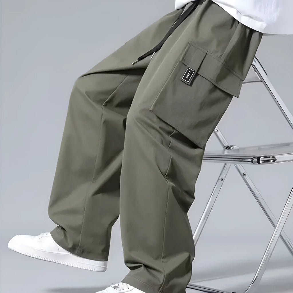 Boys' straight leg cargo pants in army green with drawstring waist and large cargo pockets.