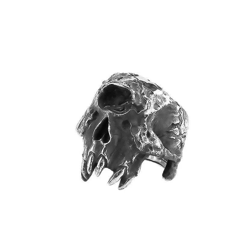 Alloy ring with a detailed one-eyed skull design on a finger, showing its metallic retro finish.