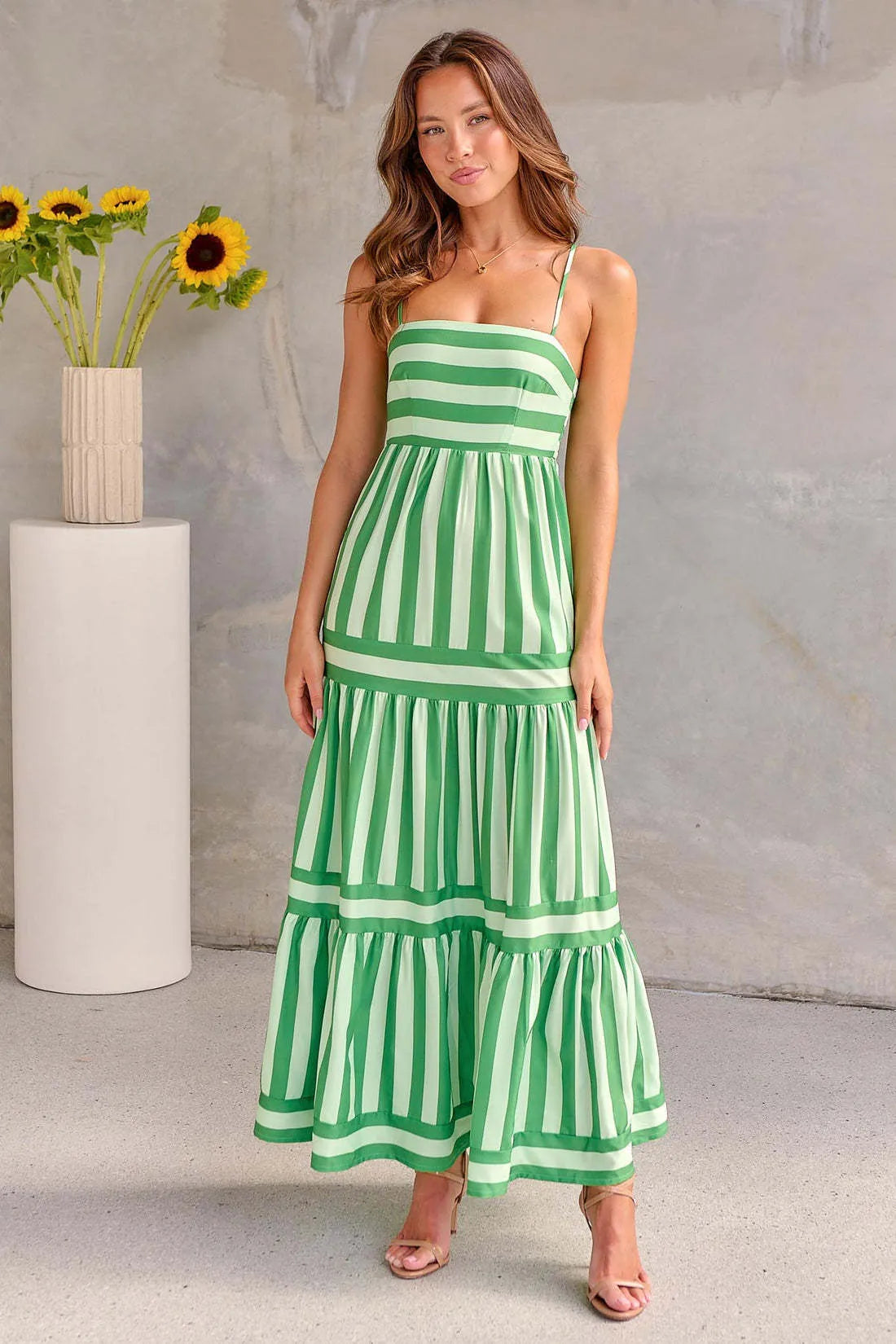 Women's striped summer dress with suspender straps, square neckline, side pockets and backless design