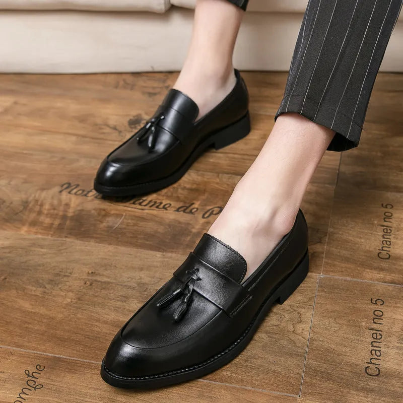 Men's black business casual slip-on shoes with tassel detail and rubber sole
