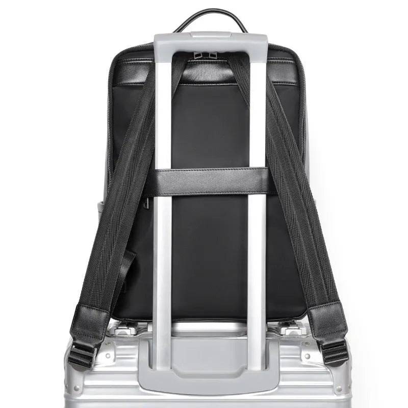 Black leather computer backpack with woven detailing and 36-55L capacity for business commute