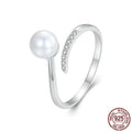 Adjustable open loop S925 sterling silver ring decorated with white shell pearls.