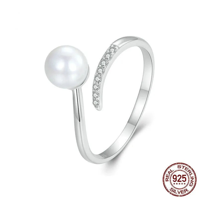Adjustable open loop S925 sterling silver ring decorated with white shell pearls.
