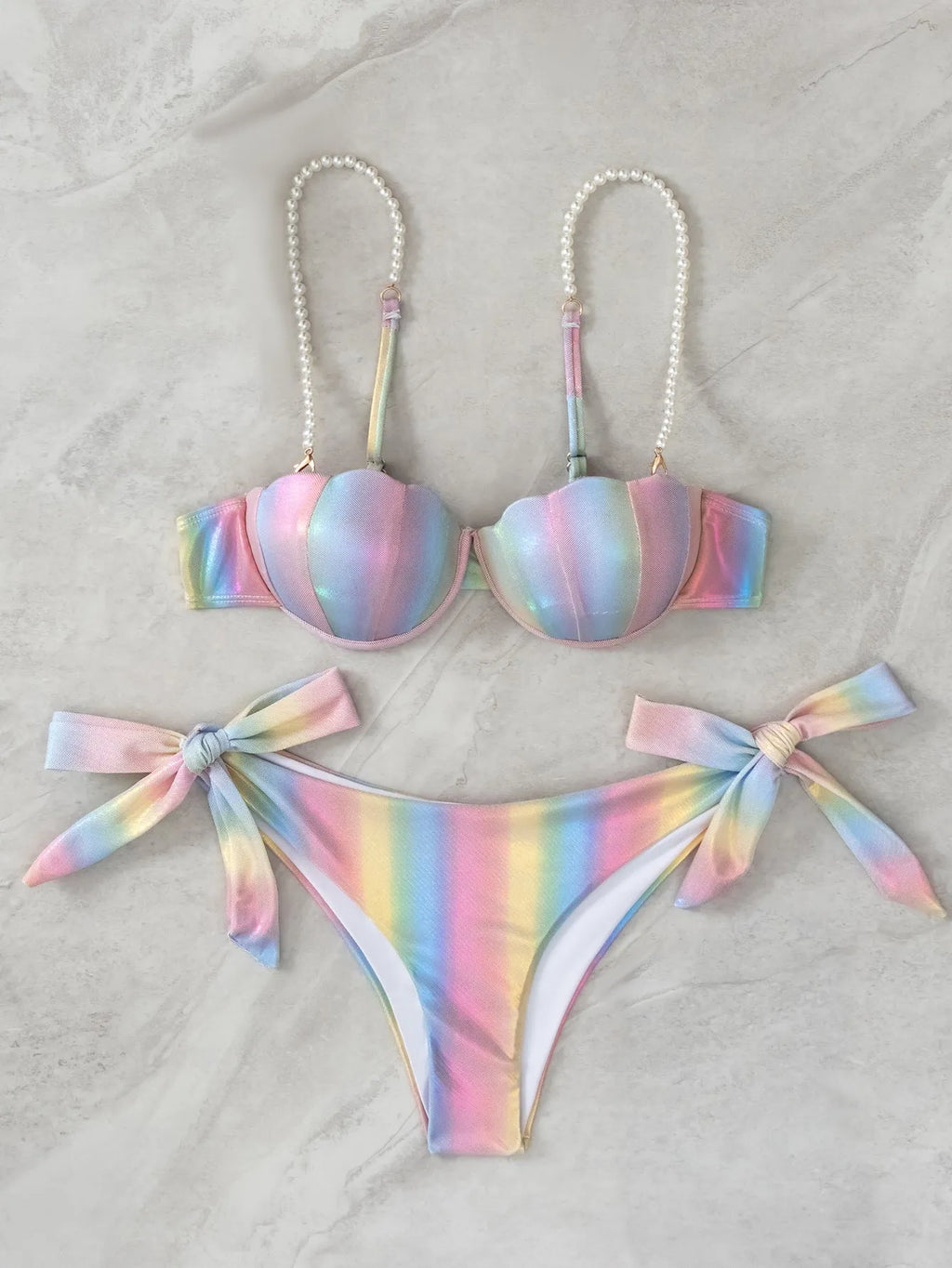 Women's shell rainbow colour split tied bikini swimsuit with triangle top on a neutral background.