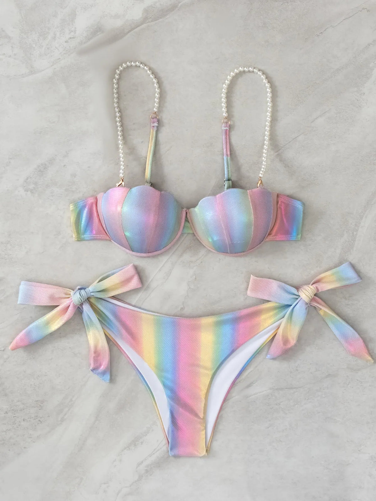 Women's shell rainbow colour split tied bikini swimsuit with triangle top on a neutral background.