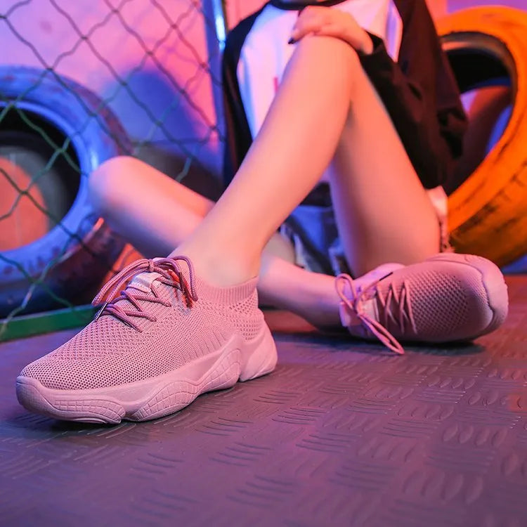 Women's low-top white woven sneakers with thick rubber sole and letter pattern detail