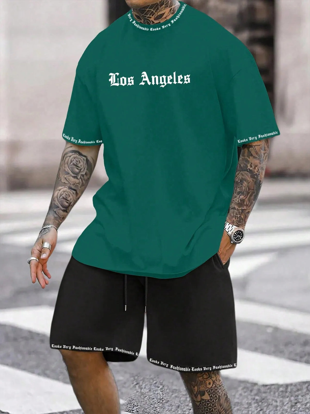 Mens blue sports style short sleeve top and shorts two-piece set on a plain background.